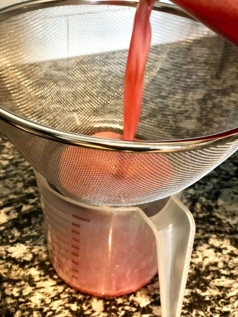 photo of watermelon puree straining in a container