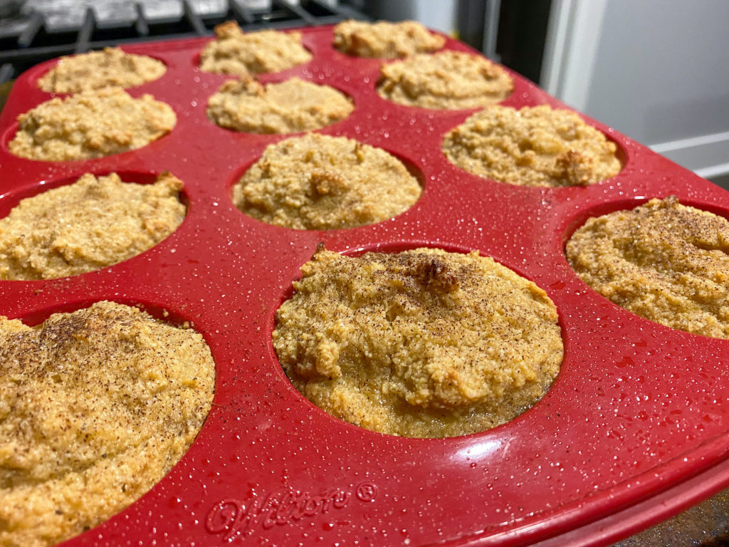 photo of almond muffins inside of a red silicone baking pan