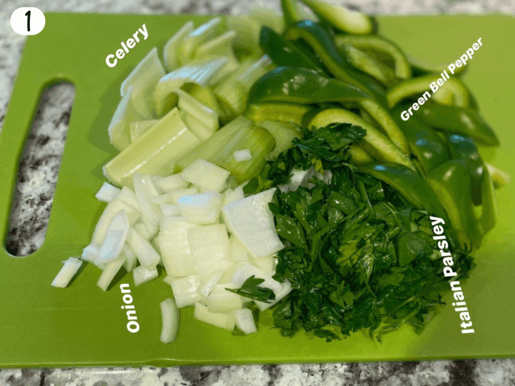Photo of turkey wings vegetables such as celery, onions, parsley, and bell peppers on a cutting board