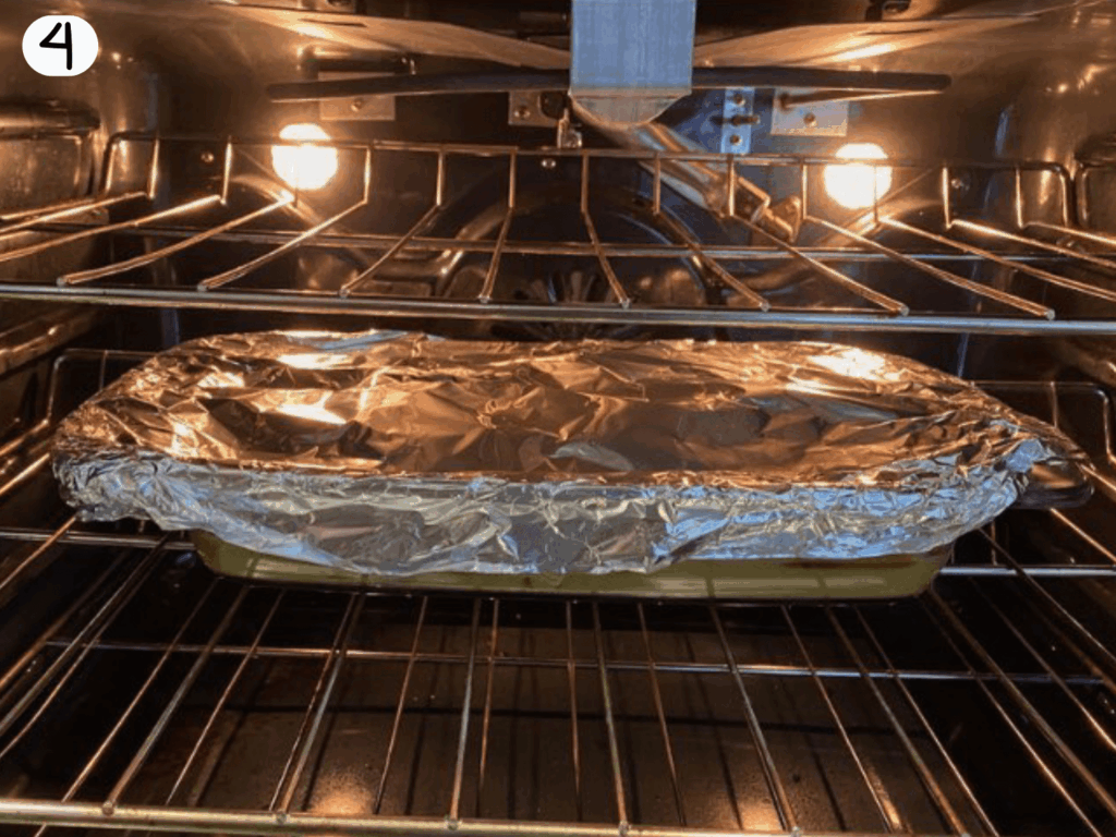 photo of turkey wings baking in the oven covered with foil in a casserole dish