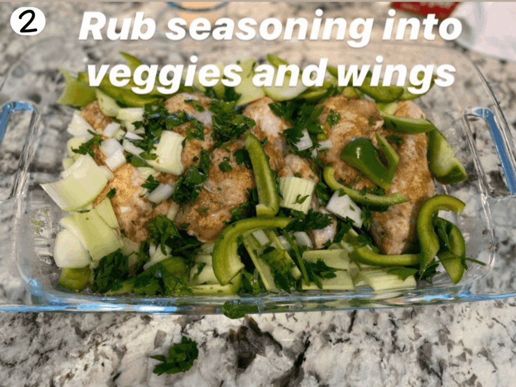 photo of turkey wings with seasoning on them covered in veggies