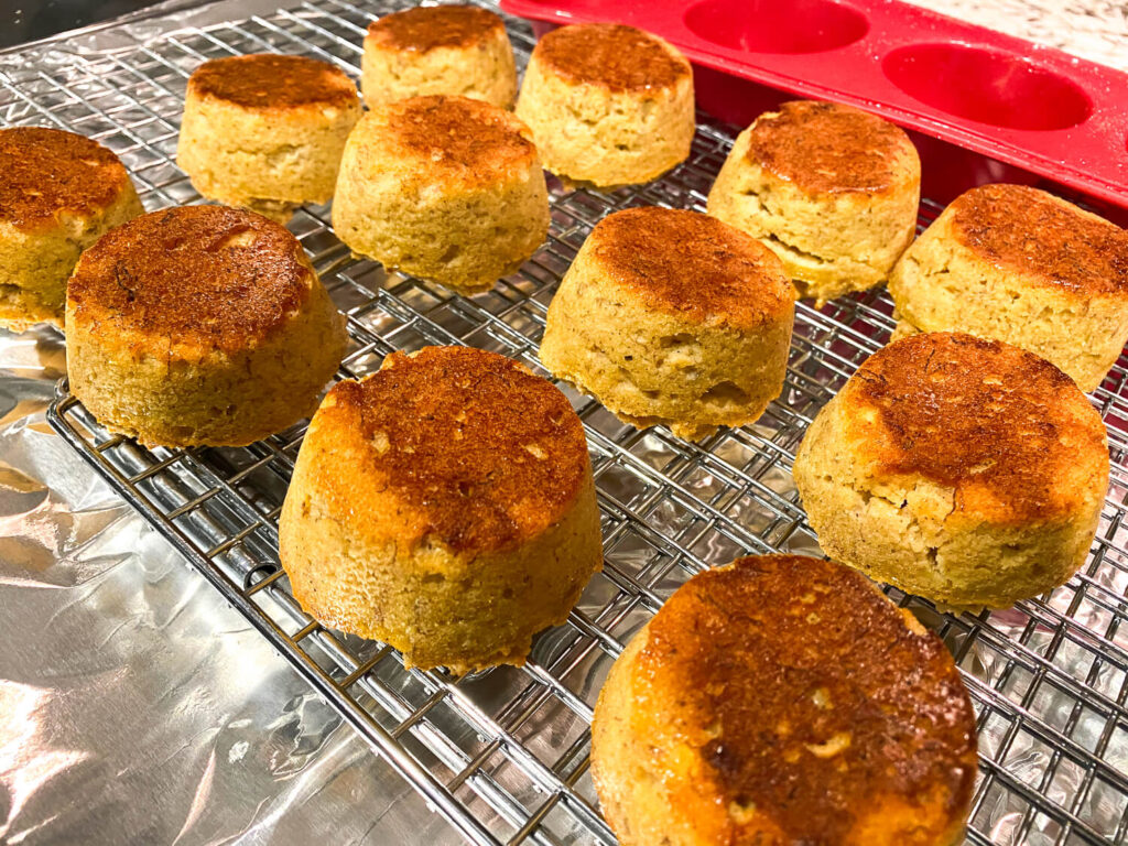 photo of Gluten Free Banana Nut bread muffins resting on a cooling rack over foil