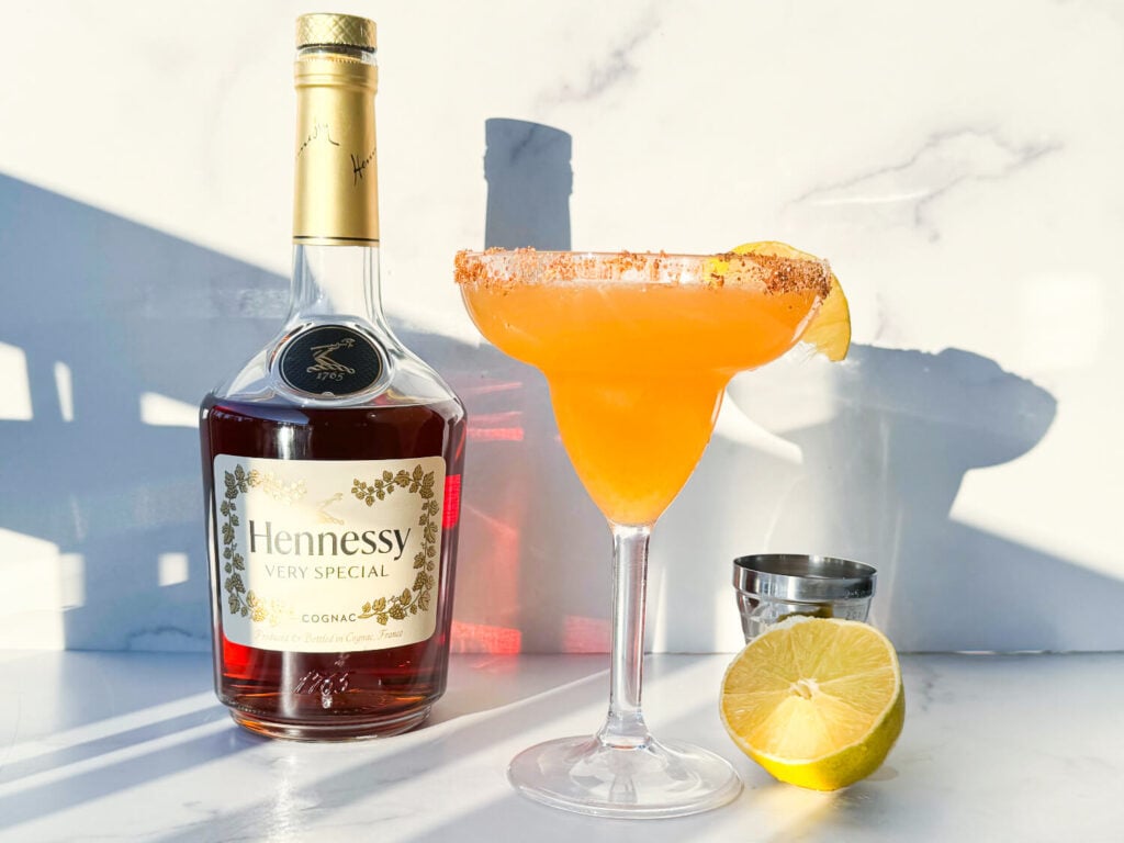 photo of a hennessy margarita next to a bottle of Hennessy