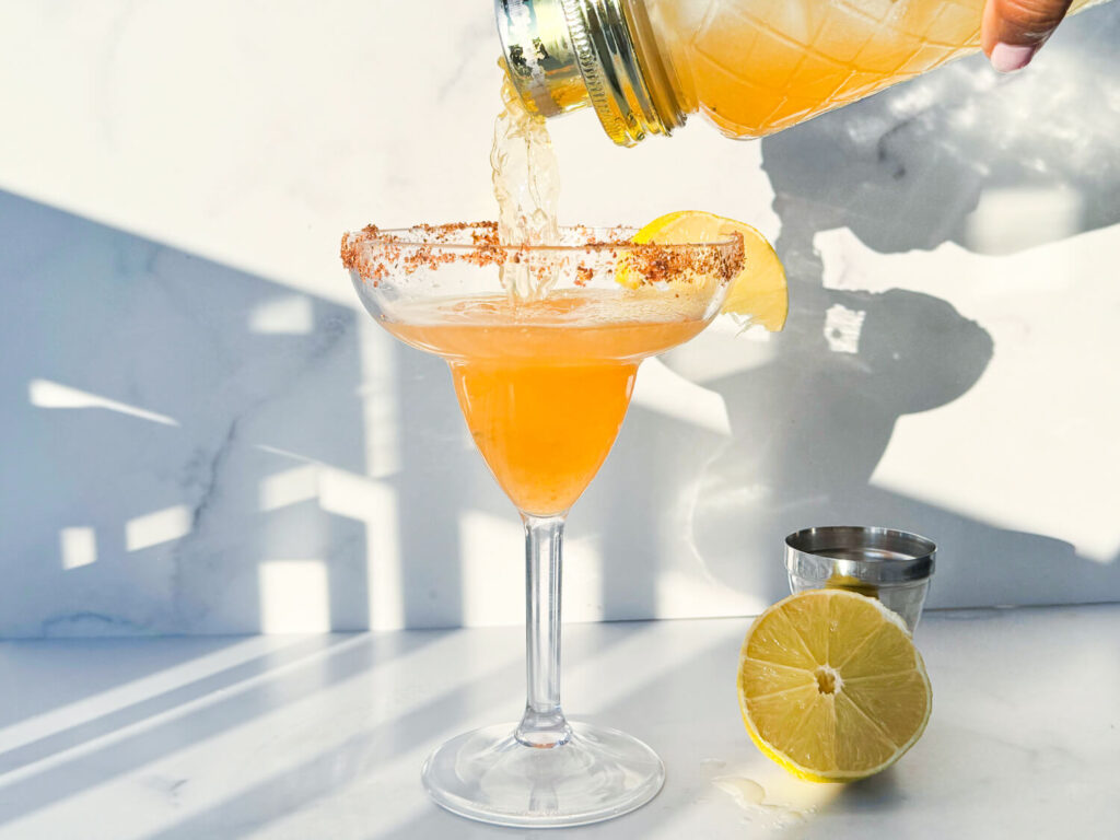 a photo of a Hennessy Margarita being poured into a Margarita glass