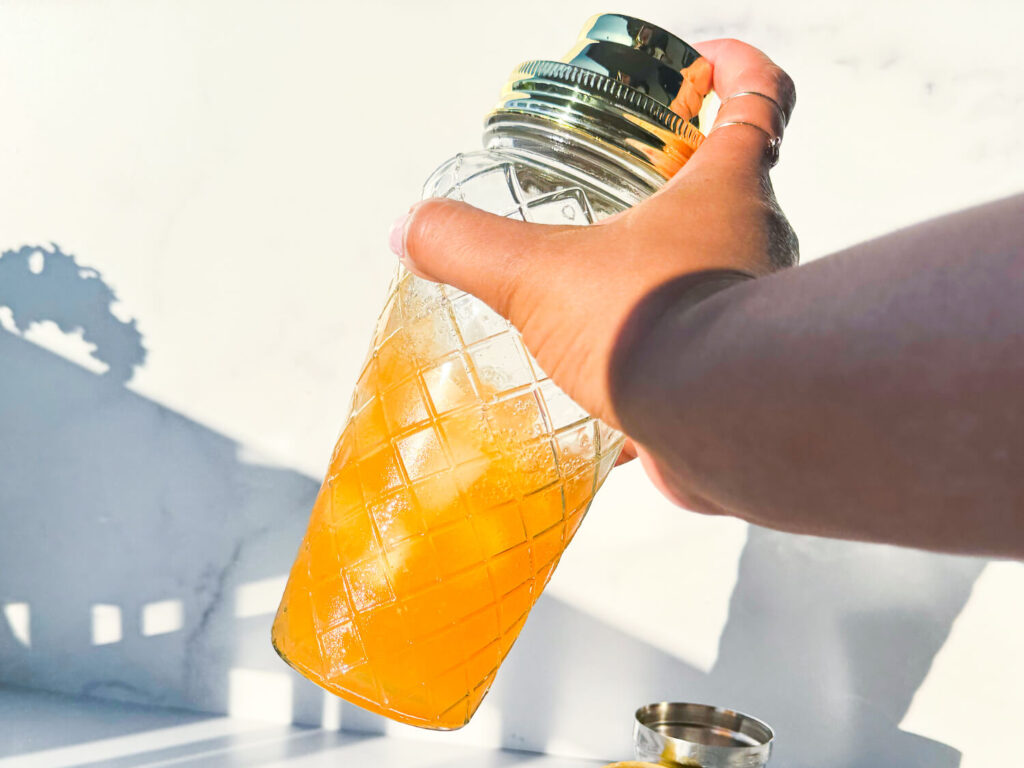 photo of a Hennessy Margarita being shaken inside of a cocktail shaker