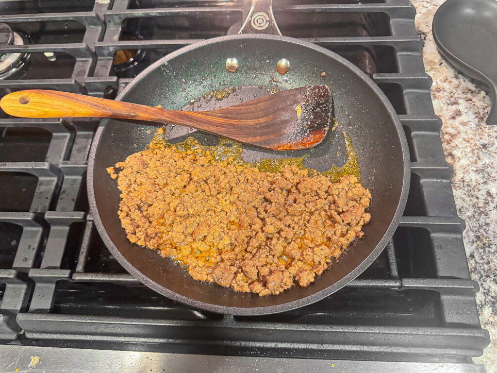 Ground beef being saut&eacute;ed in a pan with thousand island dressing