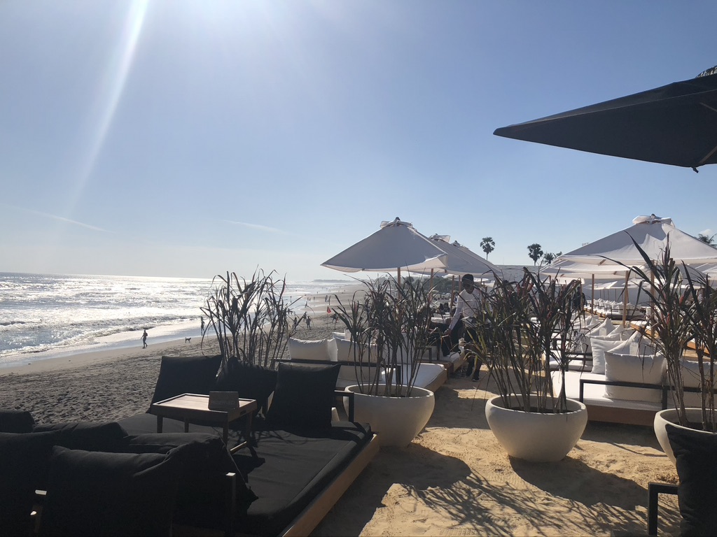 A photo of white umbrellas on the beach at finns beach club in Seminyak, Bali