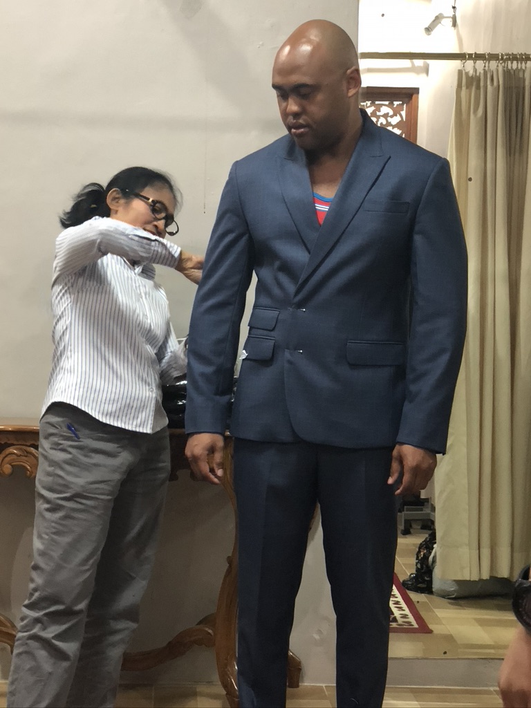 A photo of a man getting tailored at anika tailor in bali