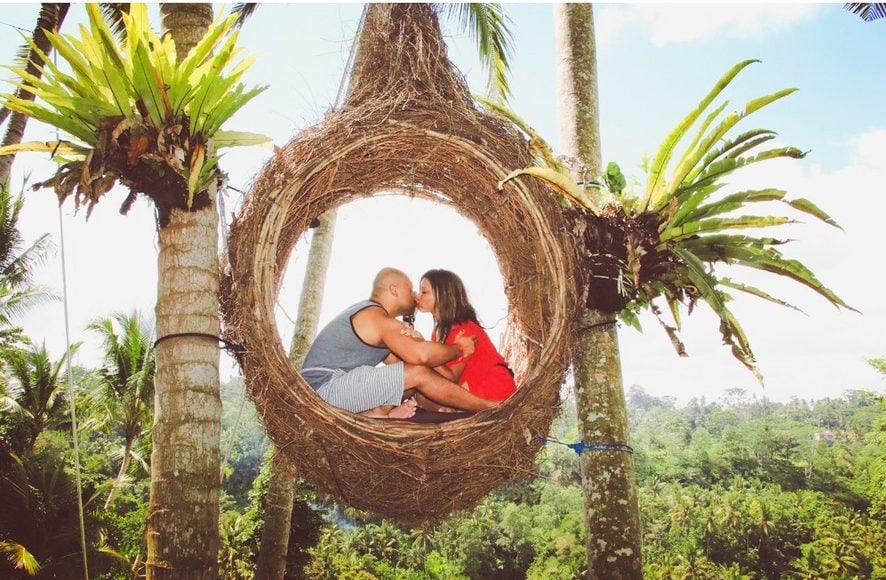 A photo of a couple inside a hanging nest at the bali swing 