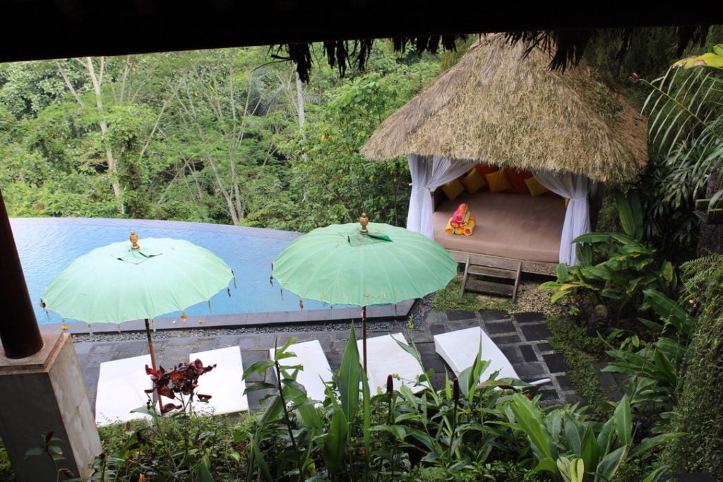Photo of hut, Bali umbrellas, and pool in the jungle of Ubud, Bali