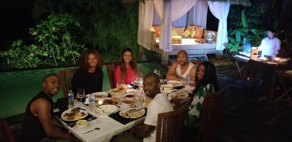 photo of a group of people enjoying dinner by the pool in Ubud Bali