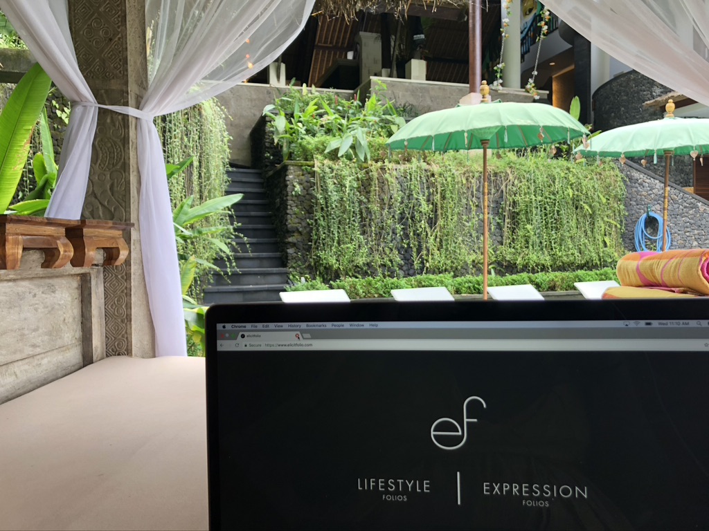 photo of Elicit Folio's laptop in front of umbrellas