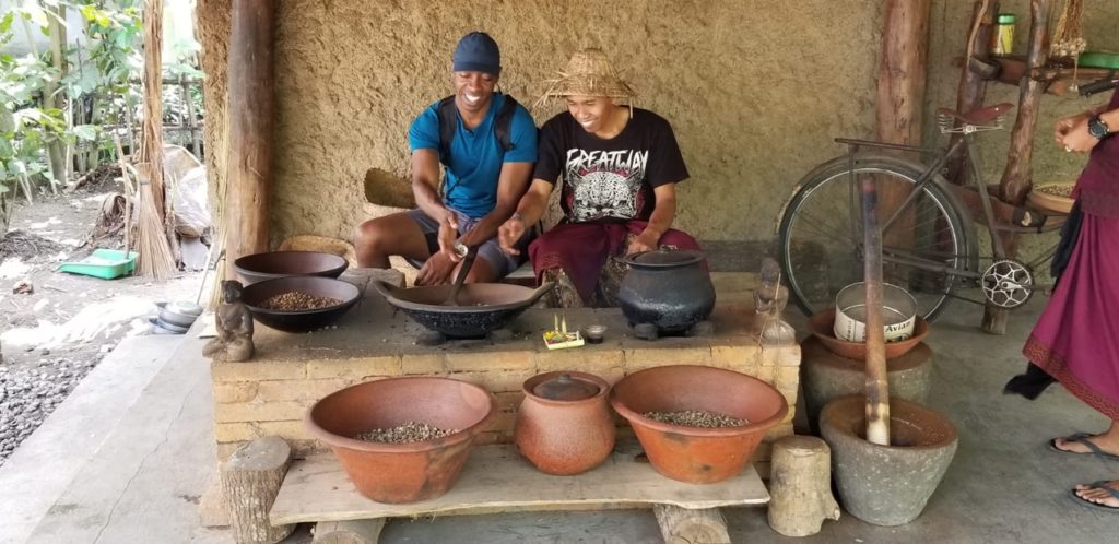 a photo of two men talking about the  luwak coffee process