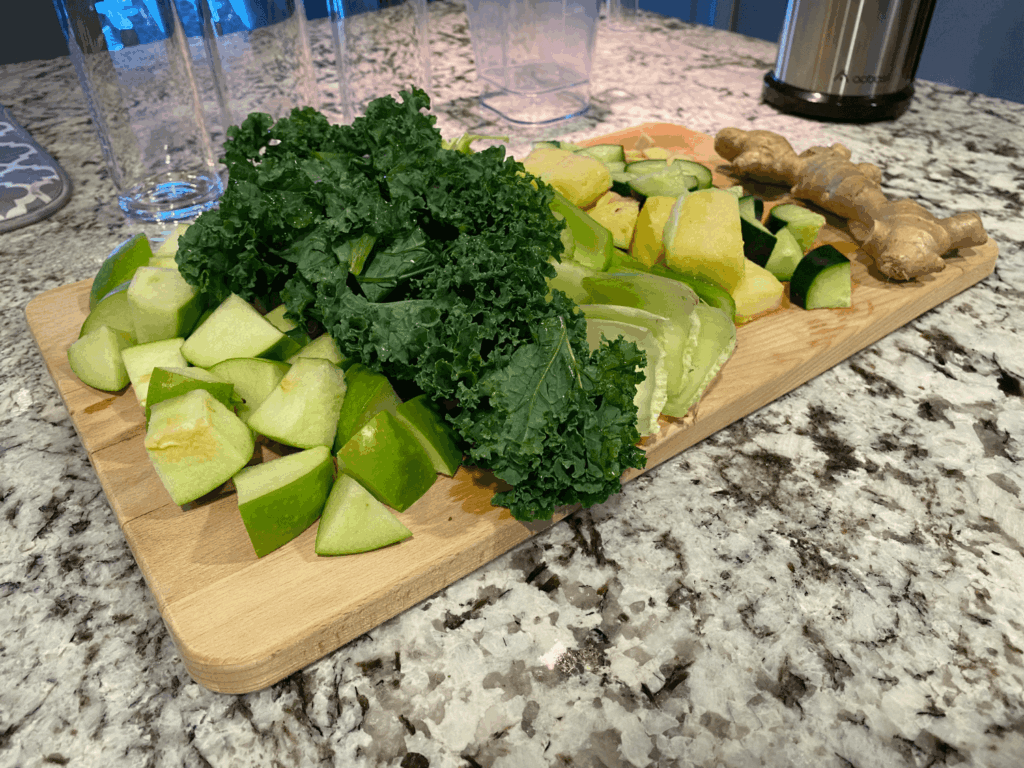 photo of chopped up ingredients on a cutting board for pineapple ginger juice