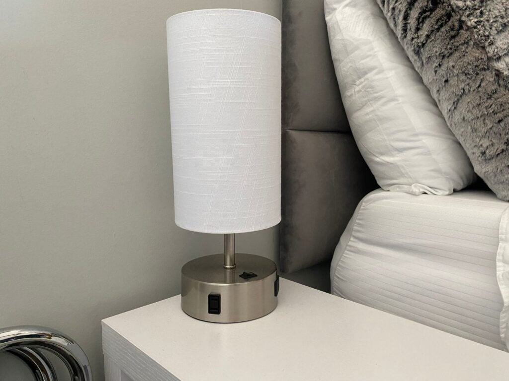 Photo of lamp on night stand with USB and AC power
