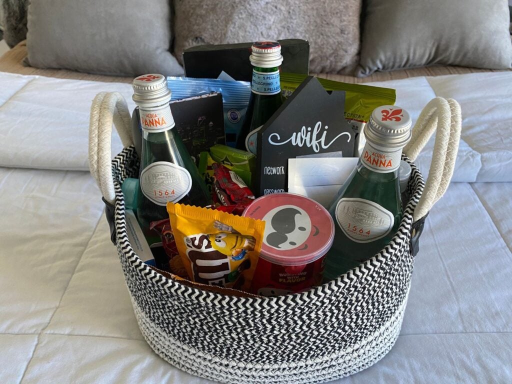 Photo of Guest bedroom welcome basket filled with gifts for guests