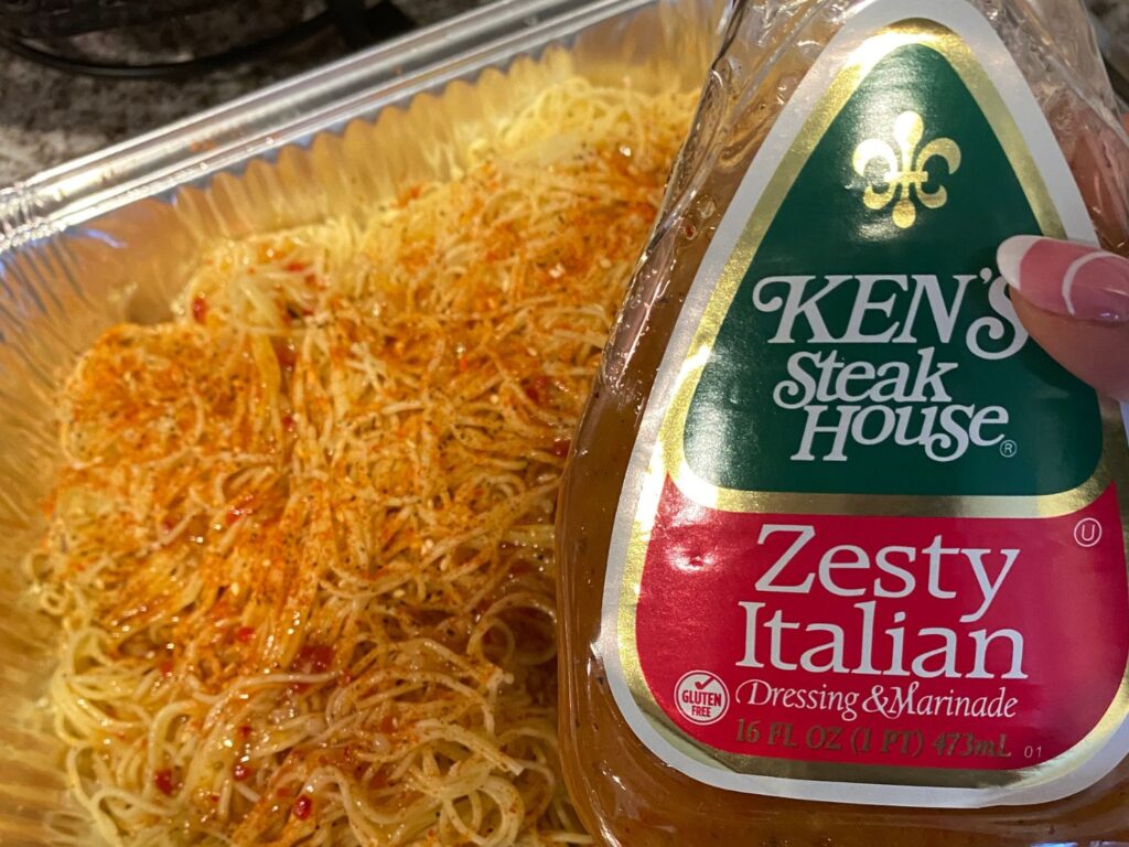 Photo of Ken's Zesty Italian Salad Dressing and pasta in the background