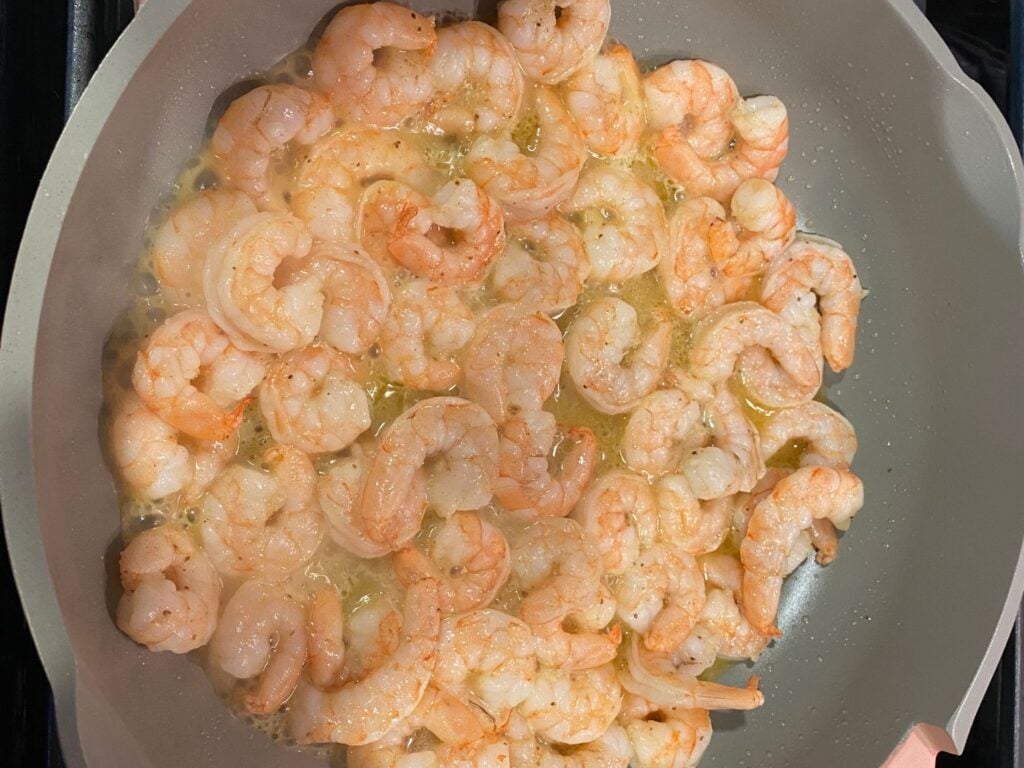 Close up view of shrimp cooking in fry pan by Elicit Folio