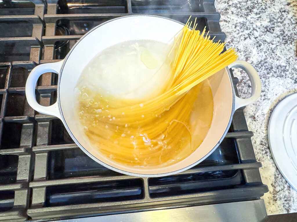 photo of pasta being added to hot water