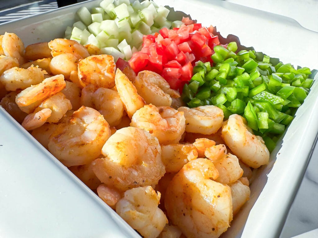 photo of shrimp pasta salad ingredients in a salad dish