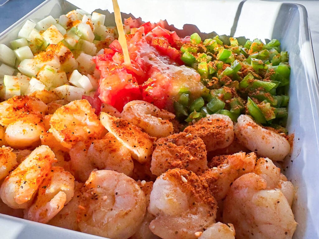 close up photo of salad supreme seasoning on top of the shrimp pasta salad