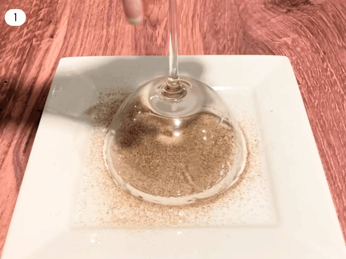 step 1 photo showing the glass being rimmed in cinnamon sugar
