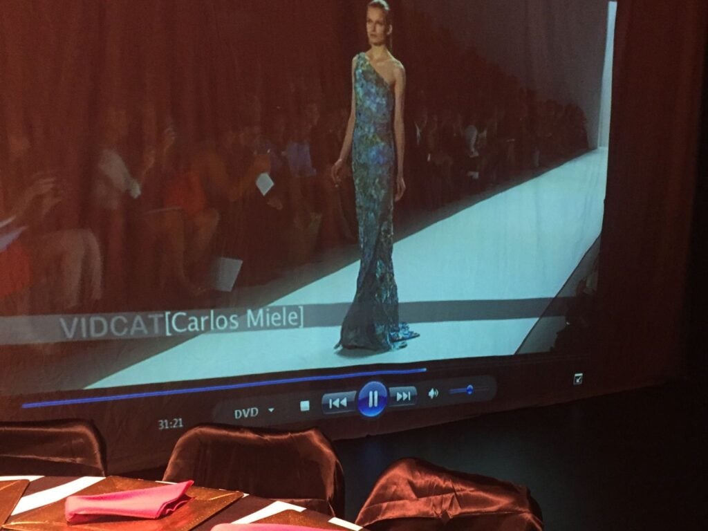 Photo of fashion show on a projector screen at a bridal shower