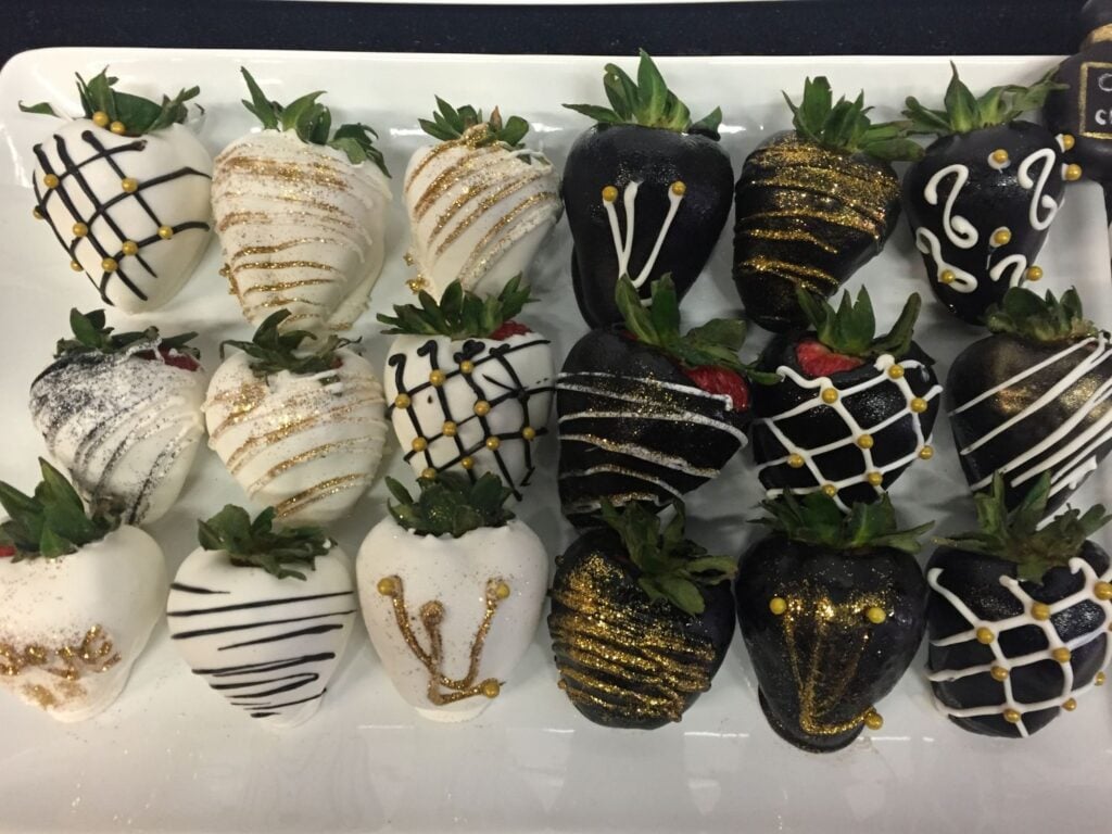photo of chocolate covered strawberries. Milk chocolate and white chocolate with gold dusting
