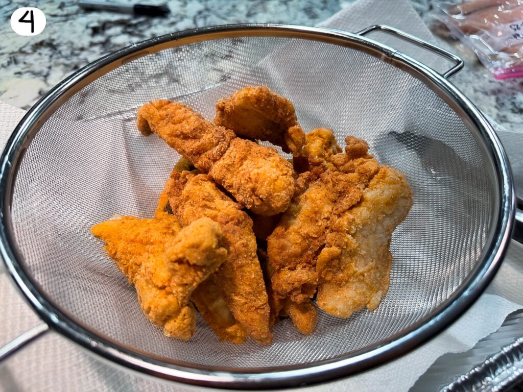 Photo of fried fish in a strainer