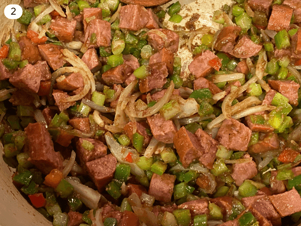 photo of browned sausage and veggies in a dutch oven