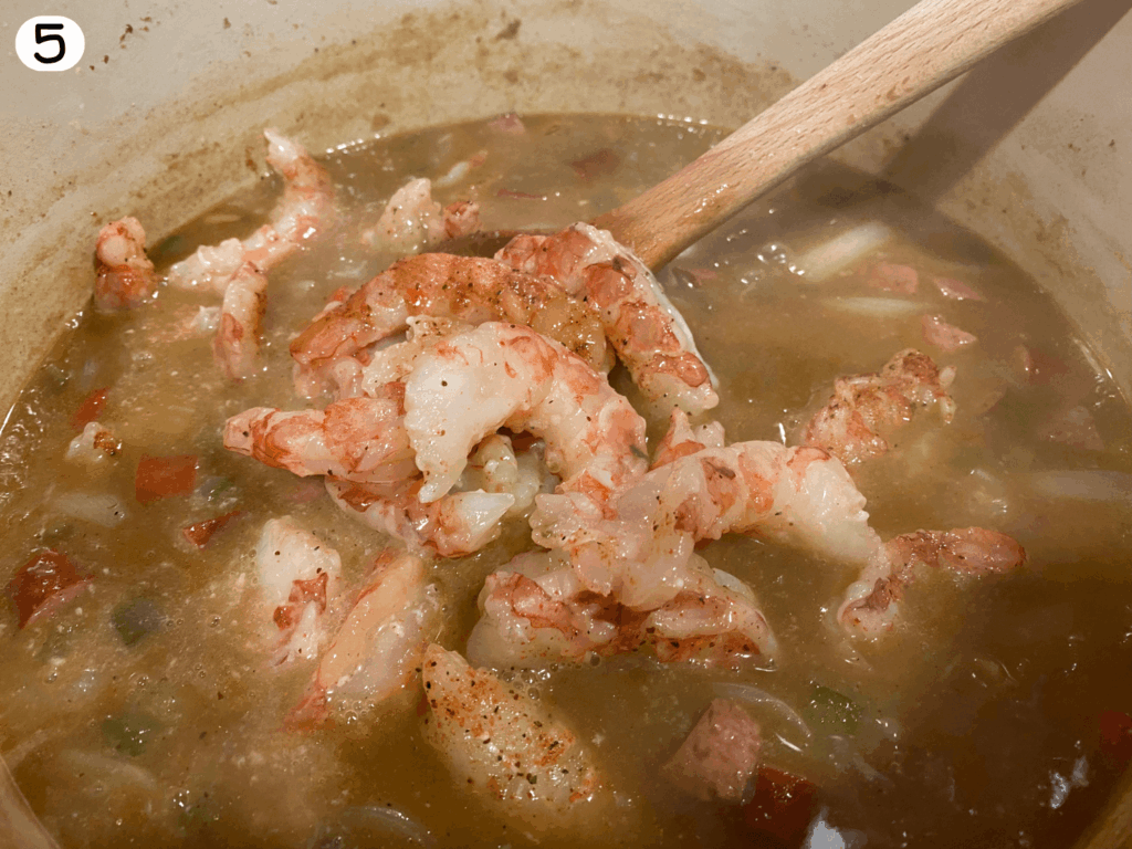 photo of seafood being added to the pot