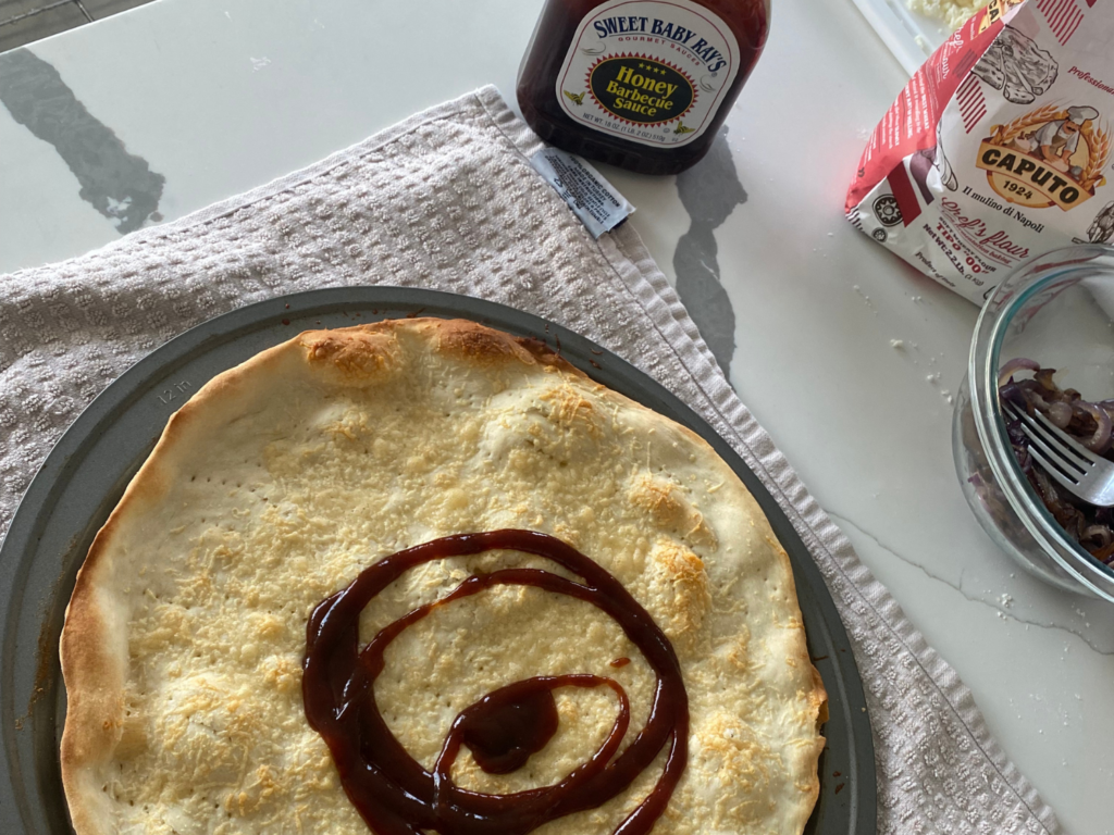 photo of par-baked pizza with BBQ sauce for BBQ chicken pizza