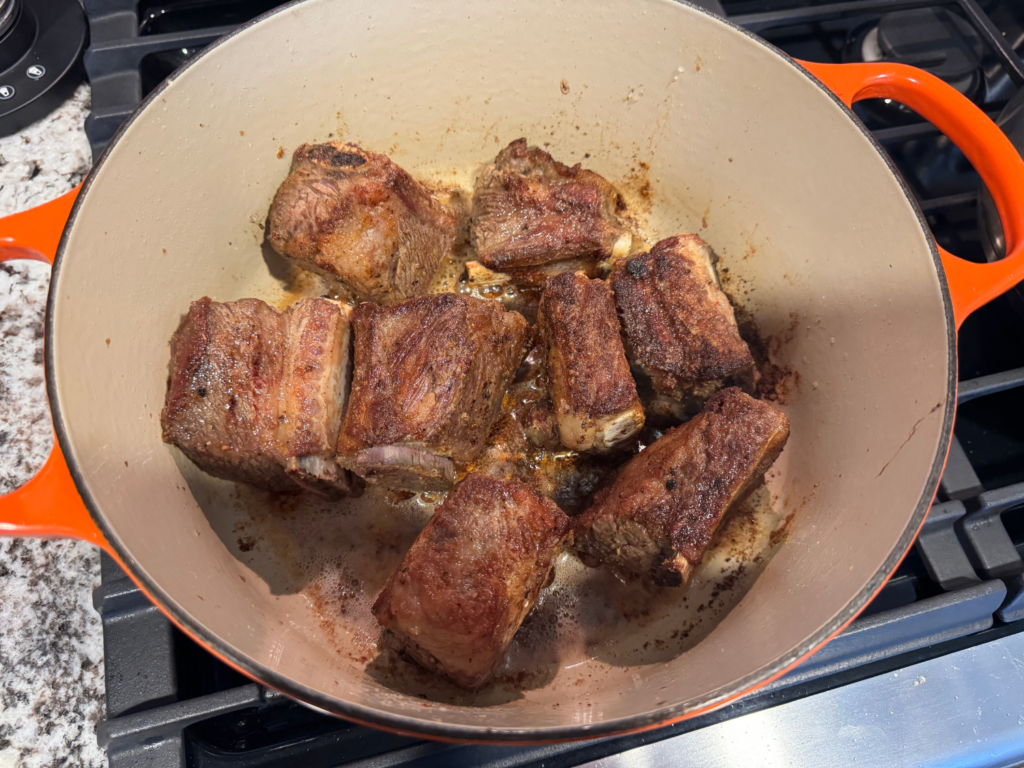photo of browned braised beef short rib in a dutch oven