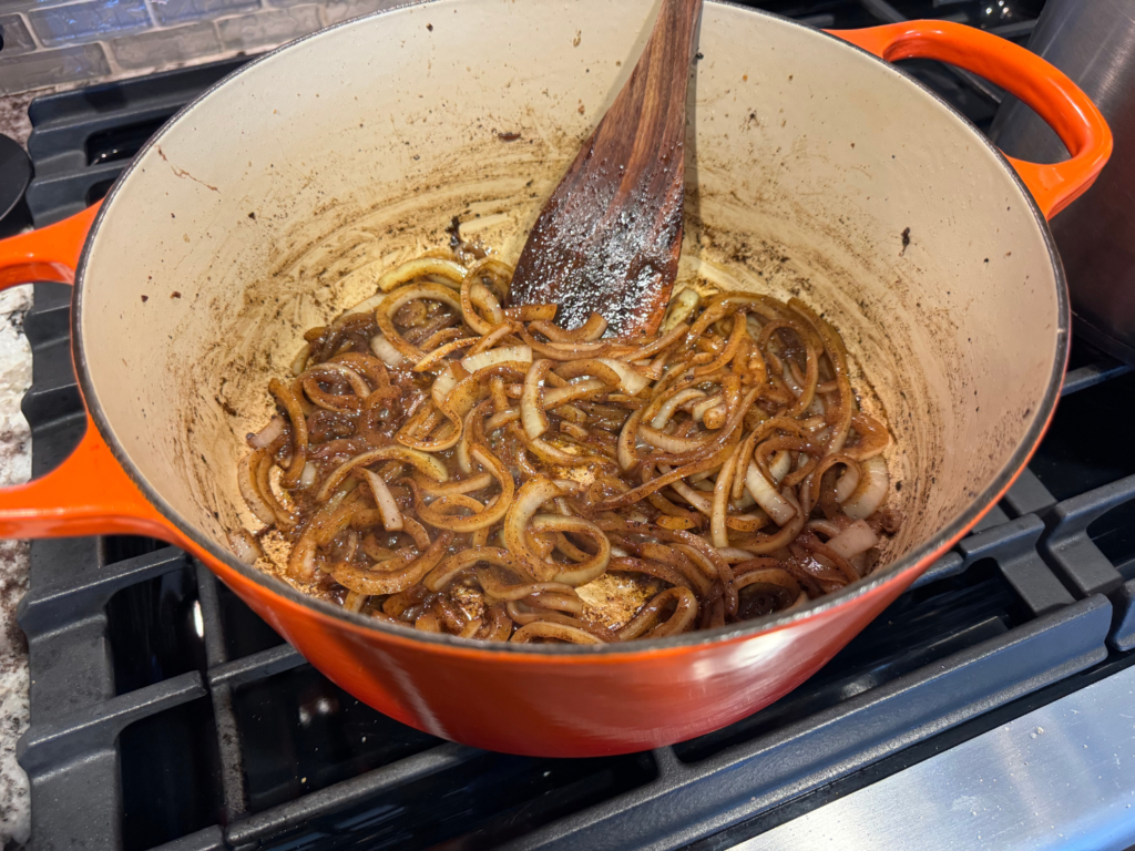 Photo of cooked onions inside of dutch oven