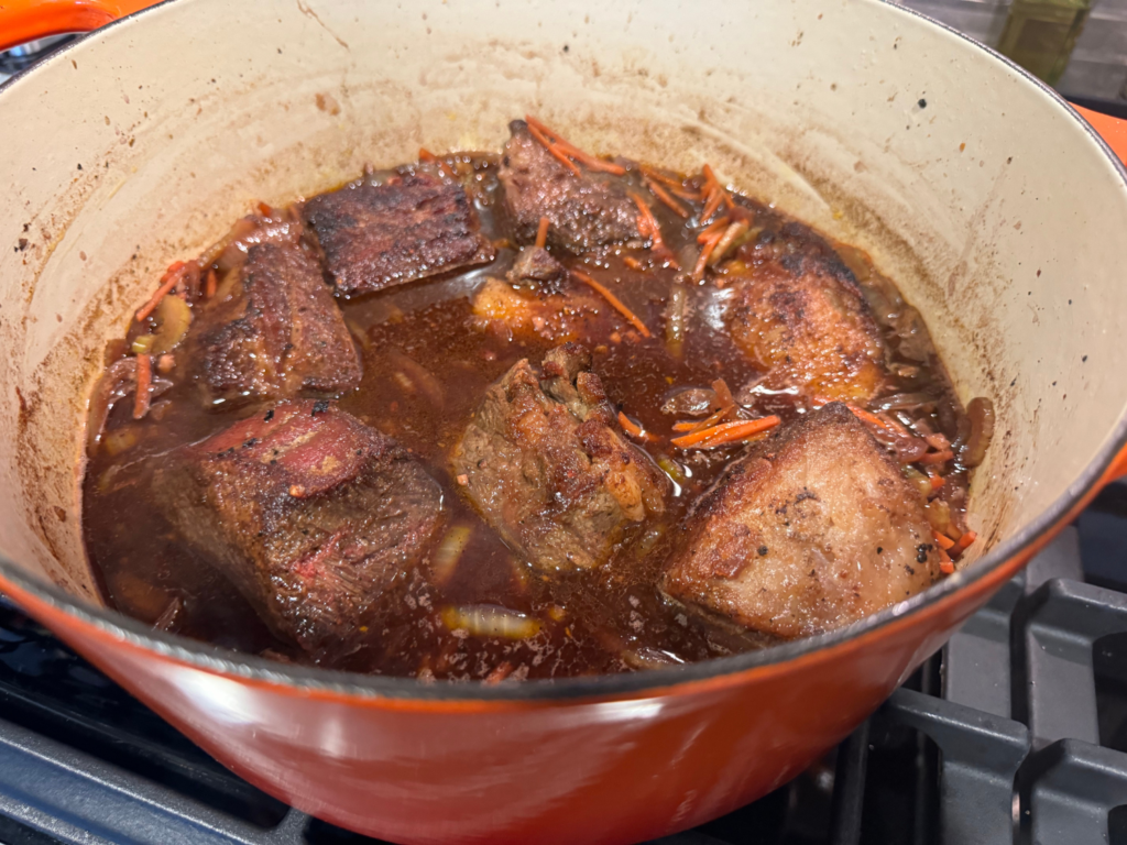 photo if braised beef short rib in a red wine reduction sauce