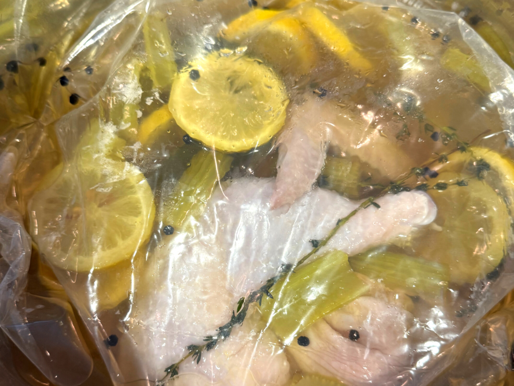Photo of chicken in a brine mixture in a bag