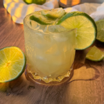 Photo of a Caipirinha Cocktail with lime wedges