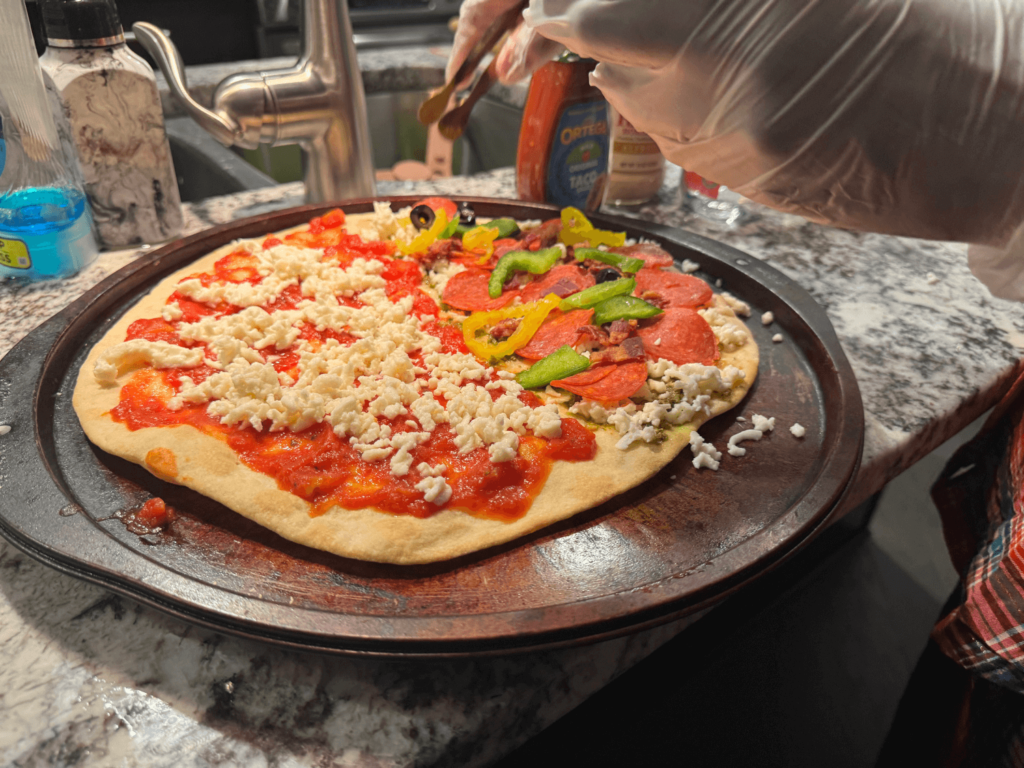 Photo of placing pizza toppings