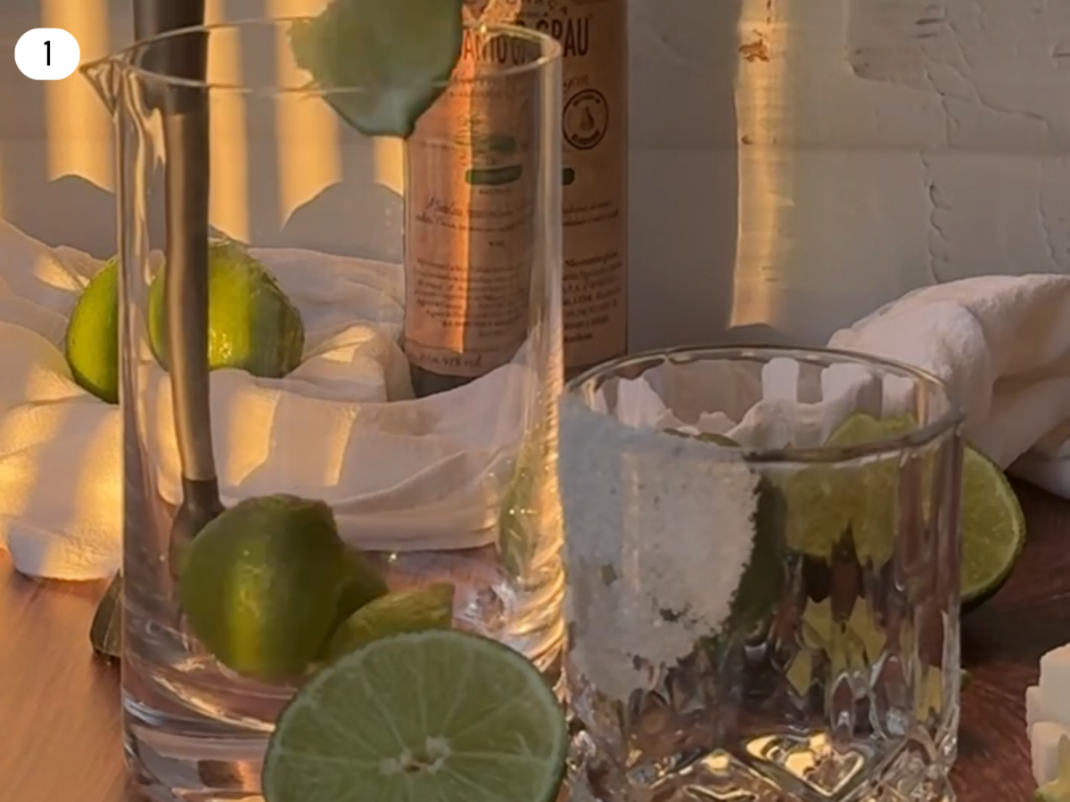 step 1 photo showing cut limes being added to a mixing glass