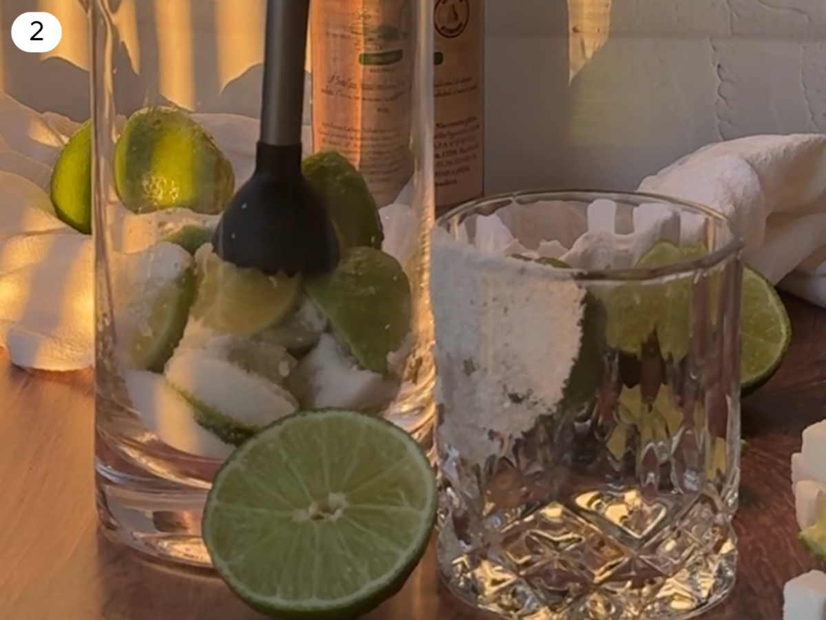 step 2 photo showing limes and sugar being muddled together