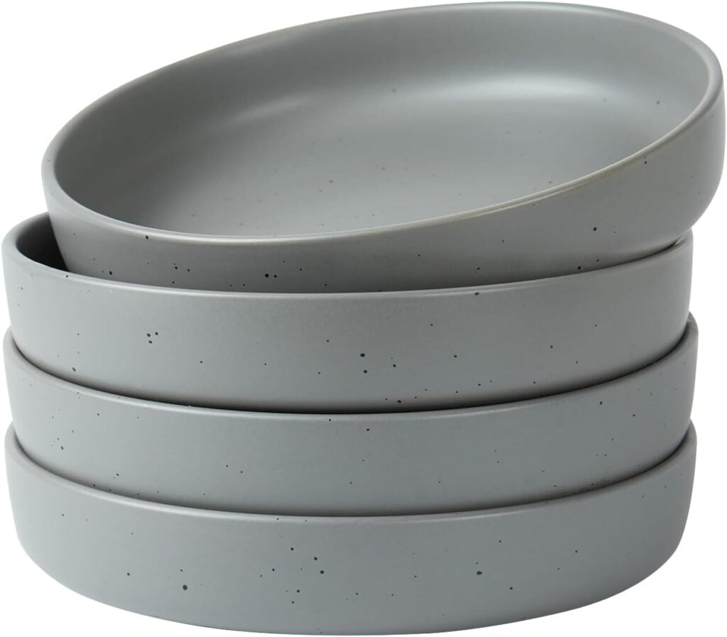 four gray matte color pasta bowls used to serve lamb chop loin dinner