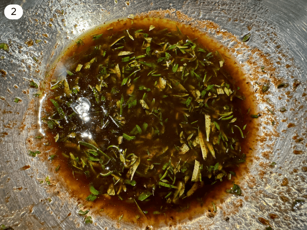 step 2 photo showing balsamic dressing ingredients mixed together with fresh rosemary and thyme