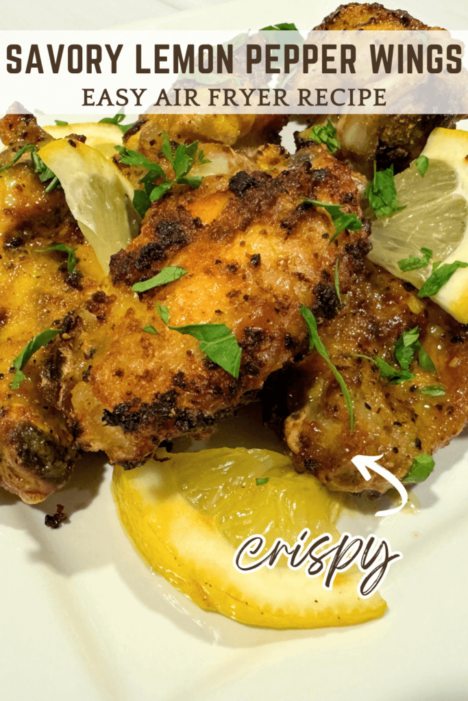 Pinterest Pin image of cooked lemon pepper chicken wings from the air fryer with lemon slices