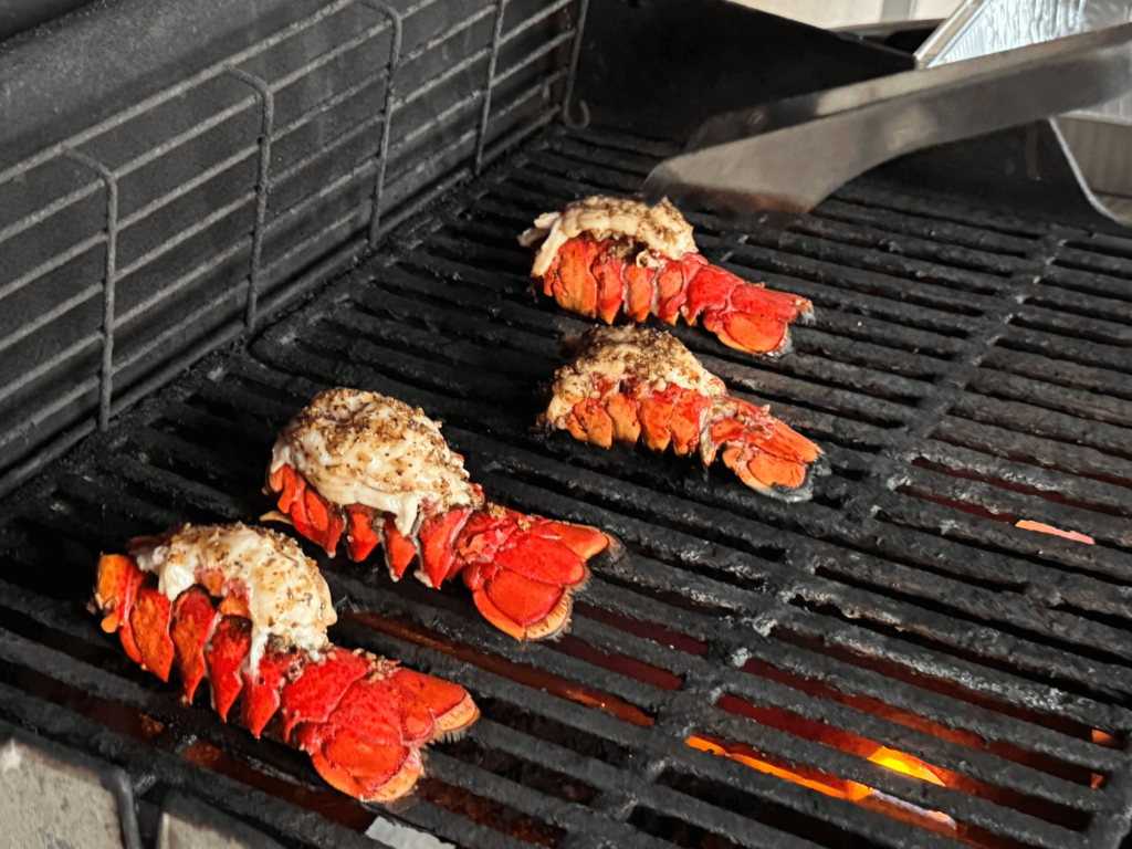 Photo of lobsters cooking on a grill