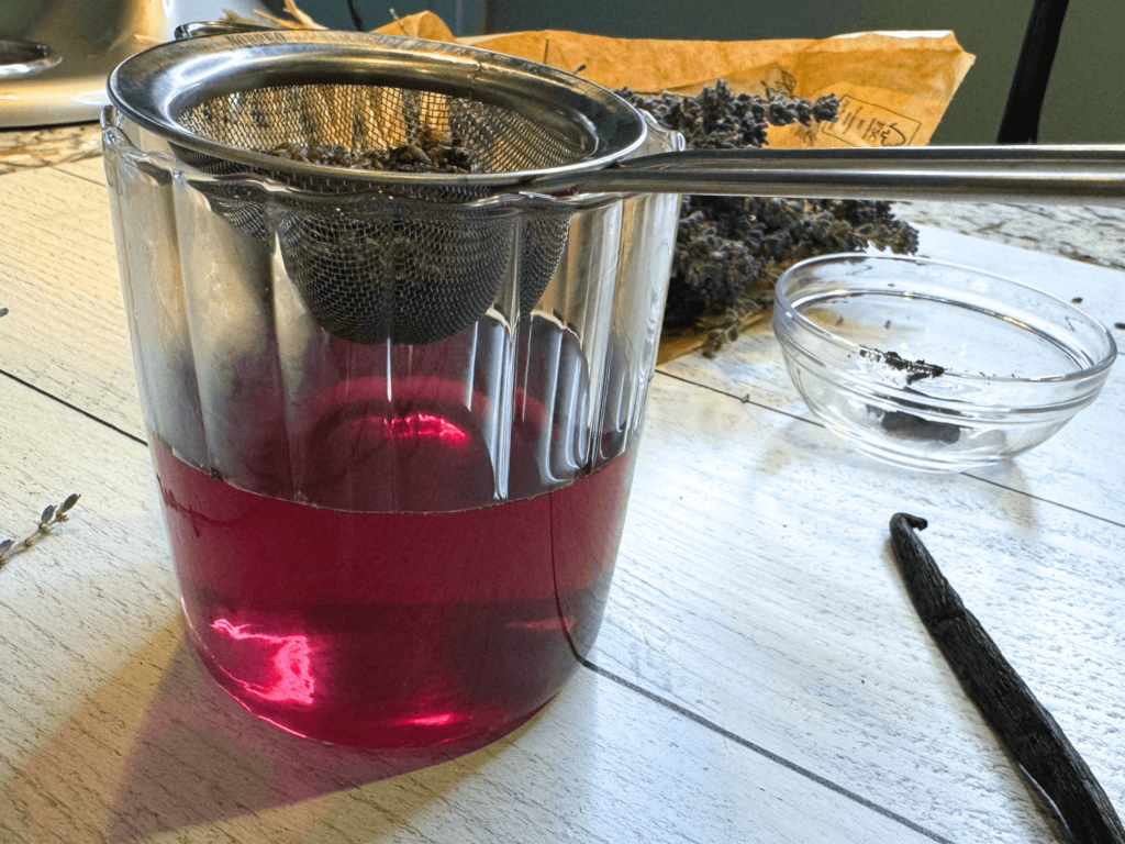 photo of lavender simple syrup with fine mesh strainer