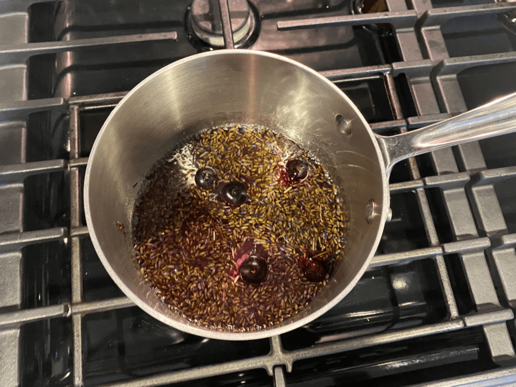 Photo of lavender flowers and blueberries in a medium saucepan