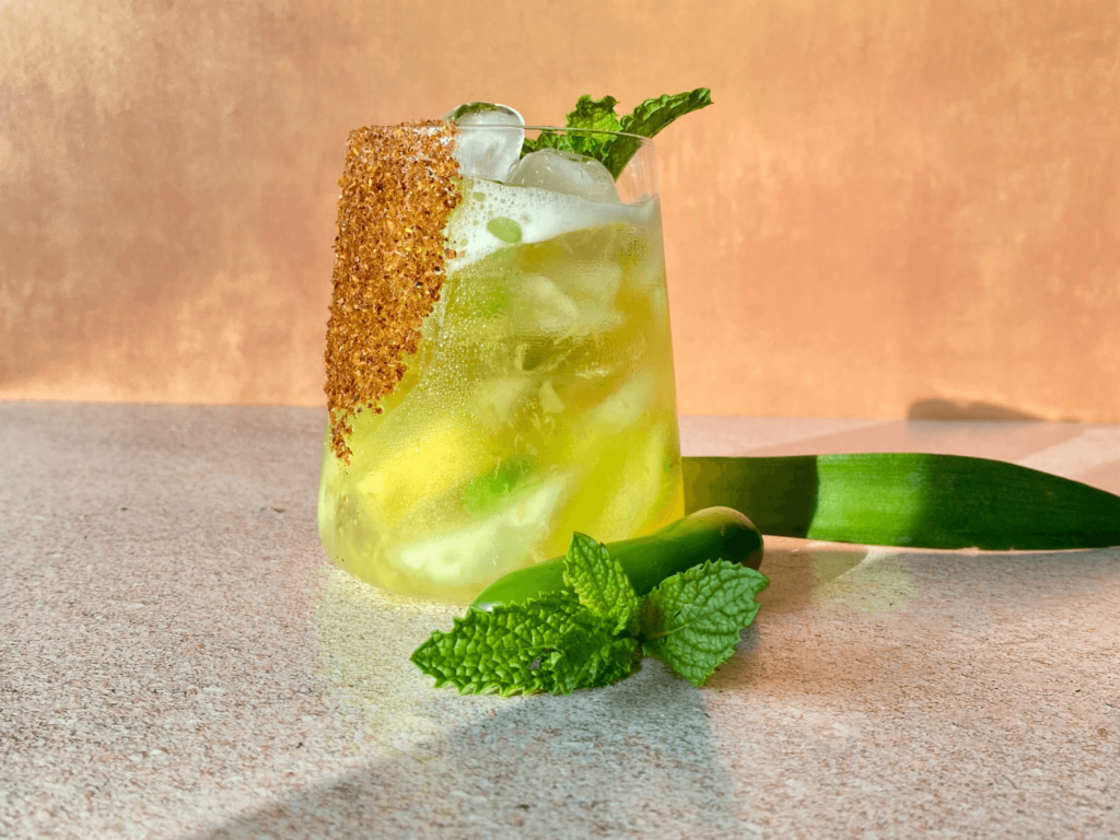 Photo of a spicy pineapple margarita with a mint garnish