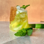 Photo of a spicy pineapple margarita with a mint garnish