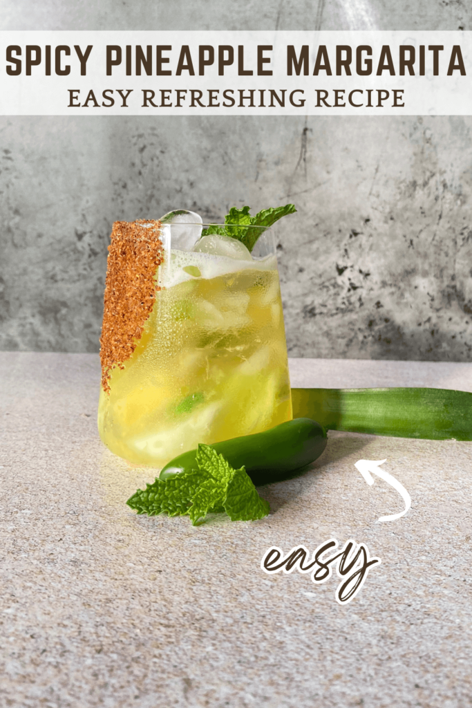 Photo of a spicy pineapple margarita with a mint garnish pinterest pin