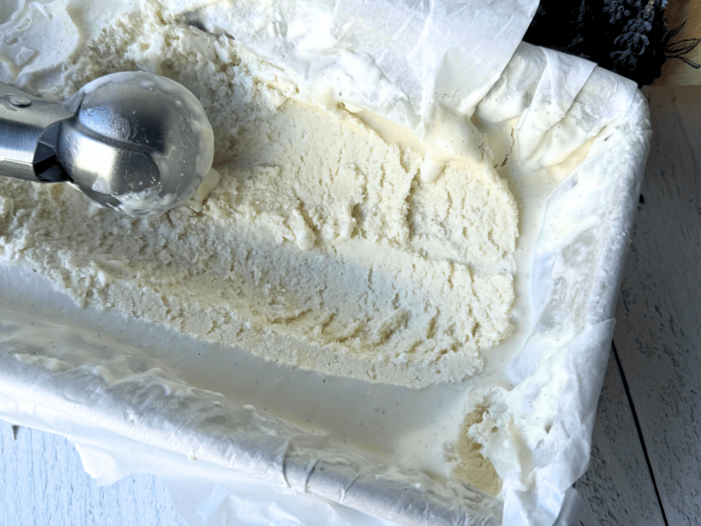 close of photo of frozen lavender ice cream with an ice cream scoop